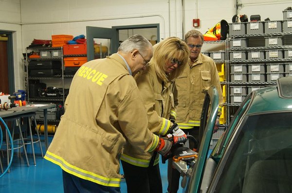 Maryland Labor Secretary Kelly Schulz tries her hand at auto mechanics at Holmatro USA in Glen Burnie. Holmatro uses apprenticeship to train highly skilled workers.