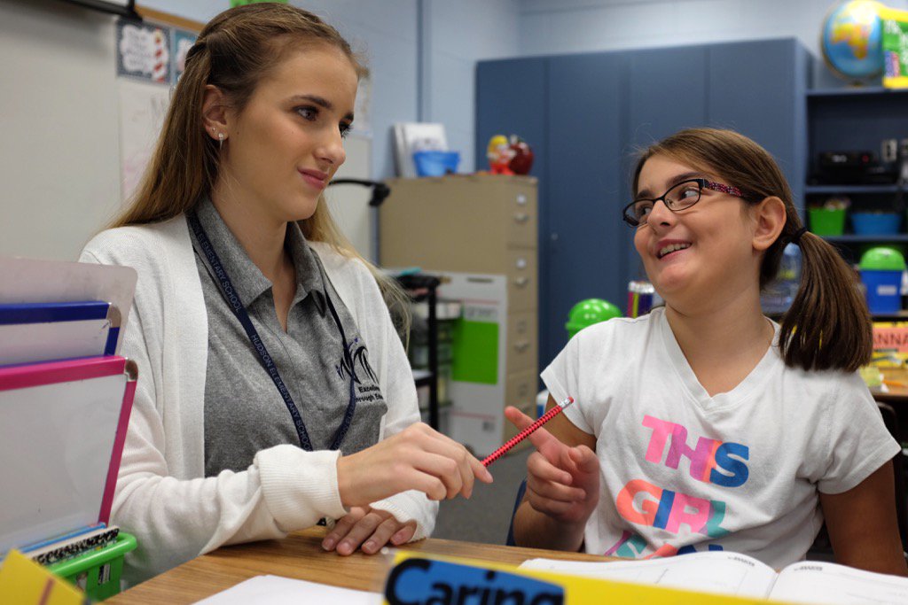 Karlee Bedson, a student in the <a href="/rrhsknights/">River Ridge Knights</a> New Teacher Academy, works with a student at Hudson Elementary.