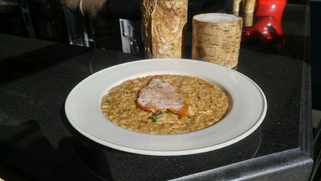 Roasted chicken risotto with brie tarragon and skin chip.
