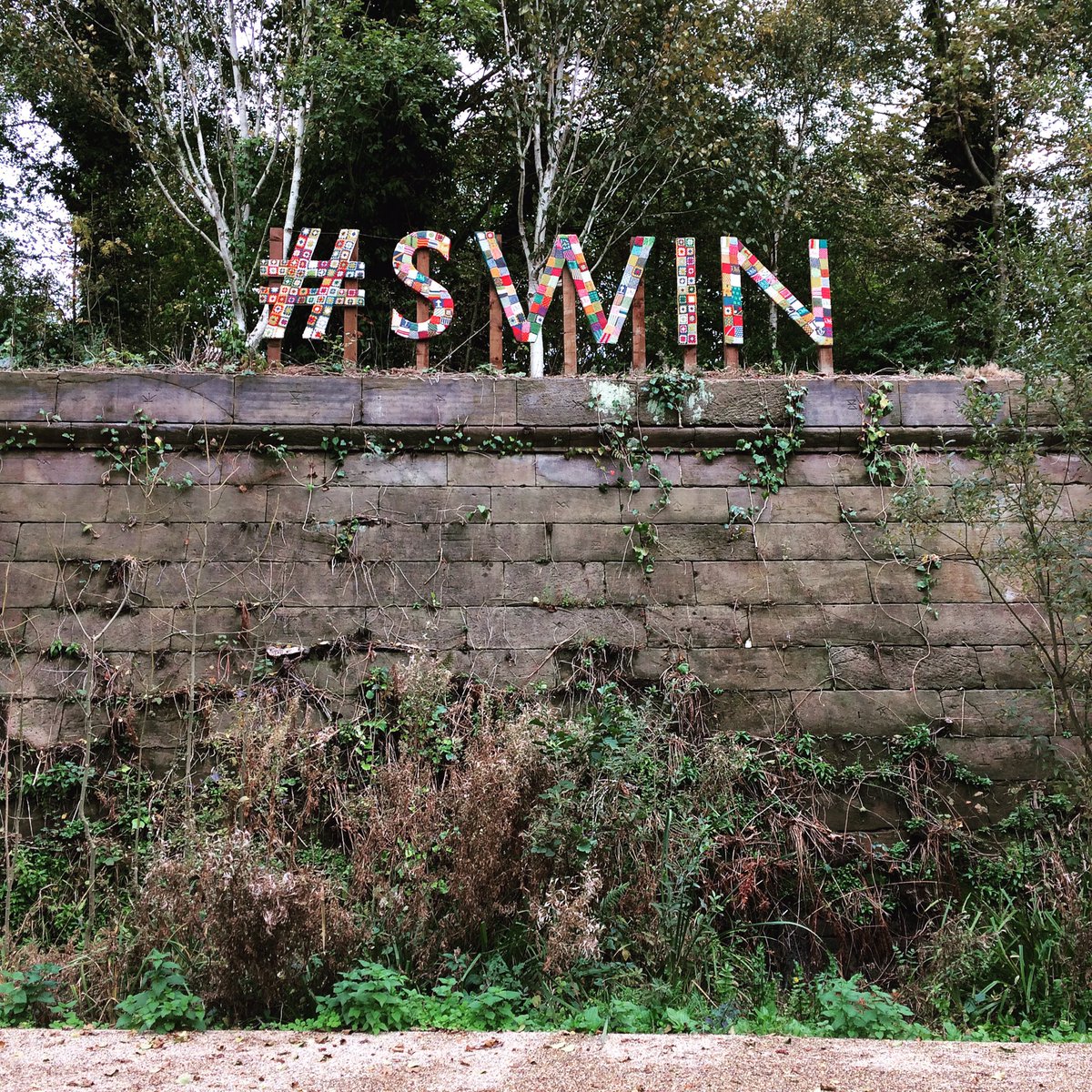 SalfordCanal's tweet photo. More knitted letters coming tomorrow #SWINGIEST #Barton Aqueduct Pocket Park #salford @artyarn #sayitwithwool https://t.co/XaN9IlV3rK