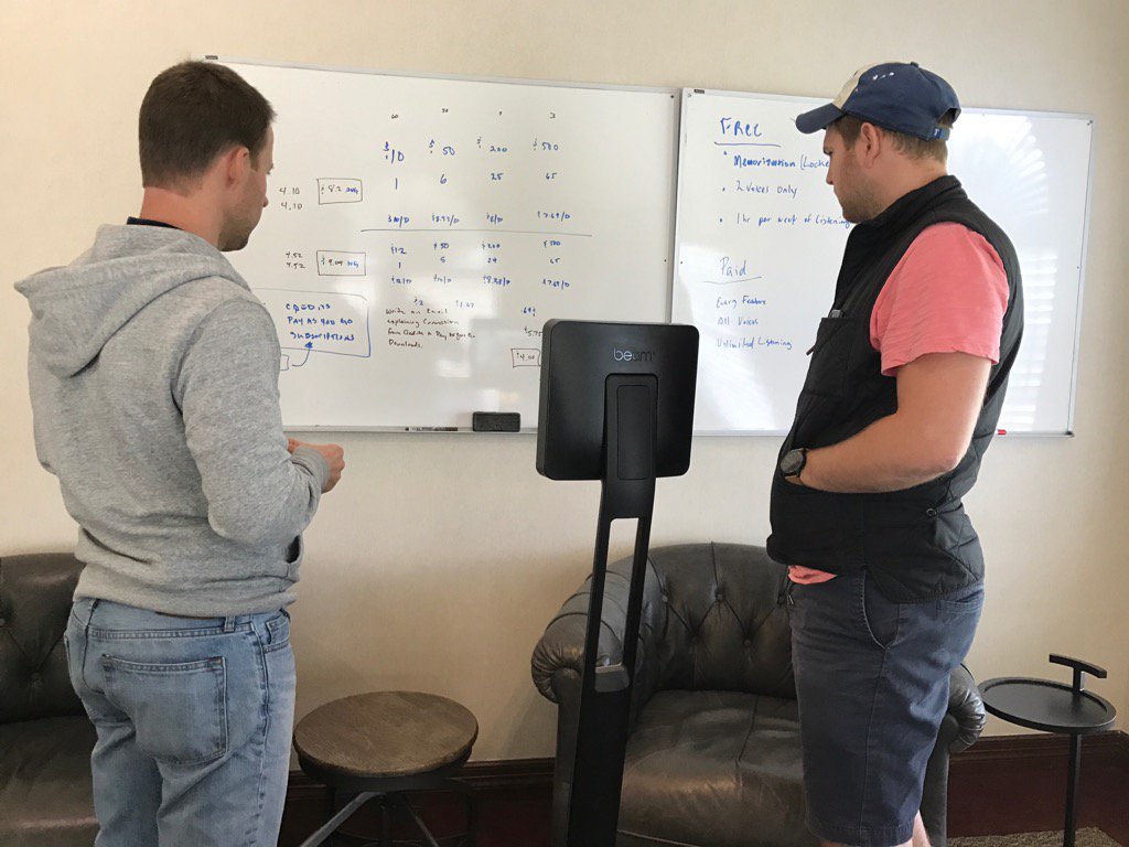 2 physical team members and 1 #remote team member gathered around the whiteboard. 

Thanks <a href="/suitabletech/">Beam Telepresence</a>
