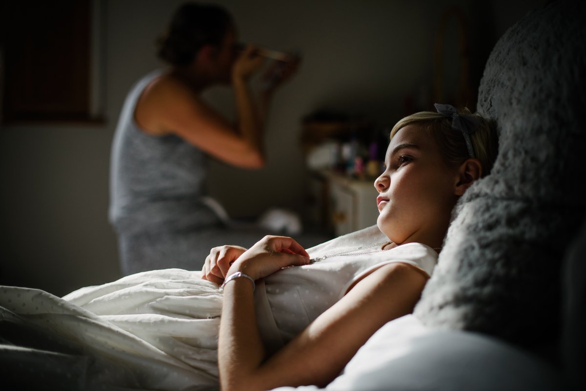 Darcey, the bride's niece and flower girl, watching the preparations.