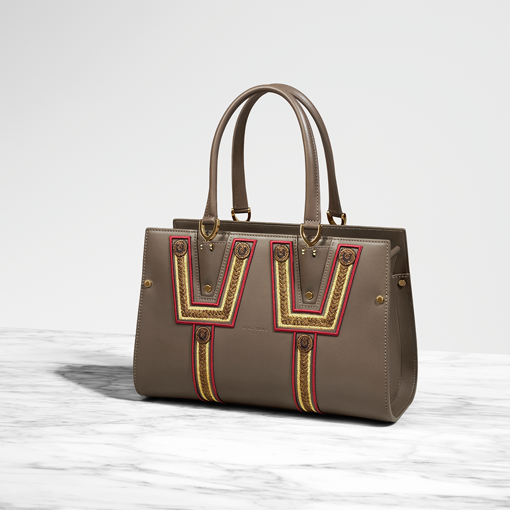 Longchamp's tweet photo. The meticulous skill of Longchamp craftsmen takes center stage in these limited edition Paris Premier handbags. #LongchampParisPremier https://t.co/Pq2vWbIj51