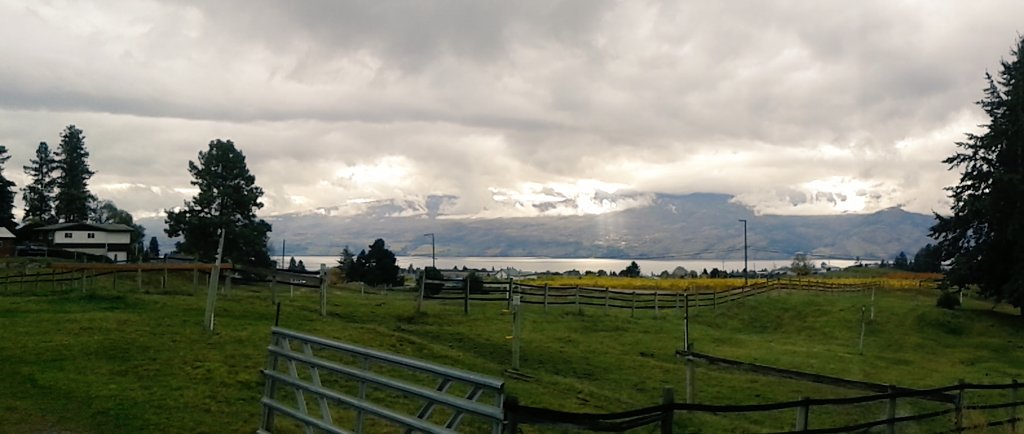 View from Elliott &amp; Reece Roads in #Westkelowna towards the Mission in Kelowna.  Sun shines down on #Okanagan Lake.