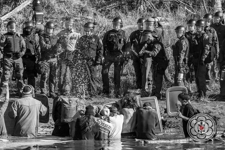 ErinSchrode's tweet photo. Powerful images from the front lines here at #StandingRock by my friend @Josue_Foto. World, pay attention. This is 2016 in the USA. #NoDAPL https://t.co/O0RnMYkFyR