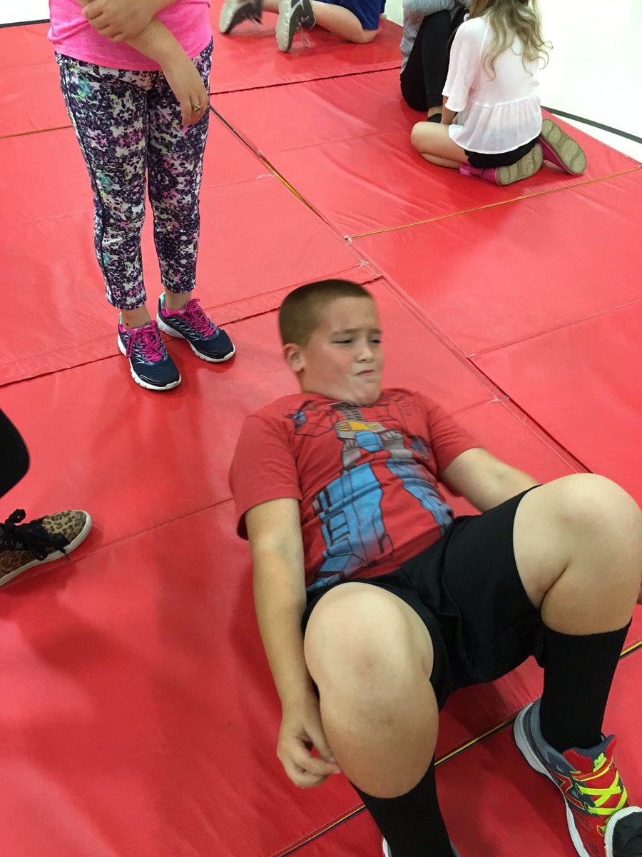 Third grade students working on curl-ups for their fitness gram during PE!