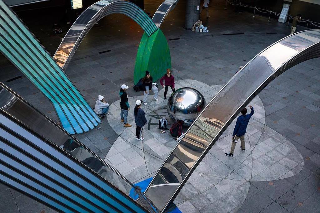 Lifesauntering's tweet photo. A group of teenagers practice their hip hop moves, watching their reflections on the spher… https://t.co/u3OfNA7TYg https://t.co/Ho8cNxFKDG