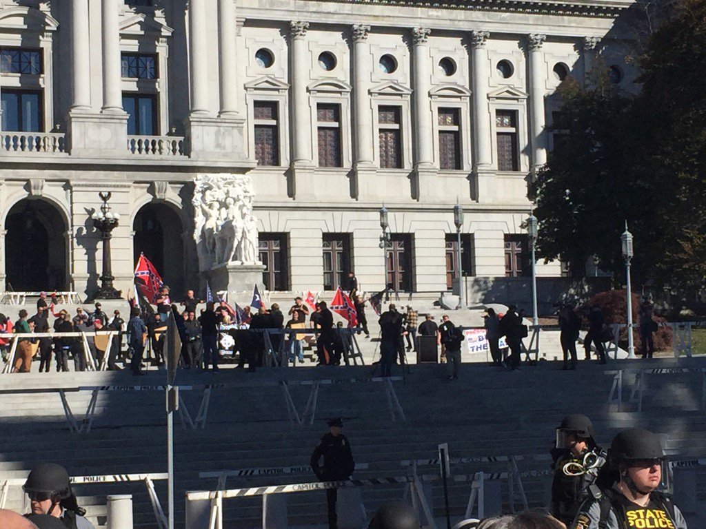 JohnLuciew's tweet photo. Confederate flags flying at PA Capitol. Neo Nazi protest in full swing. @PennLive https://t.co/NzV2kqj3Kj