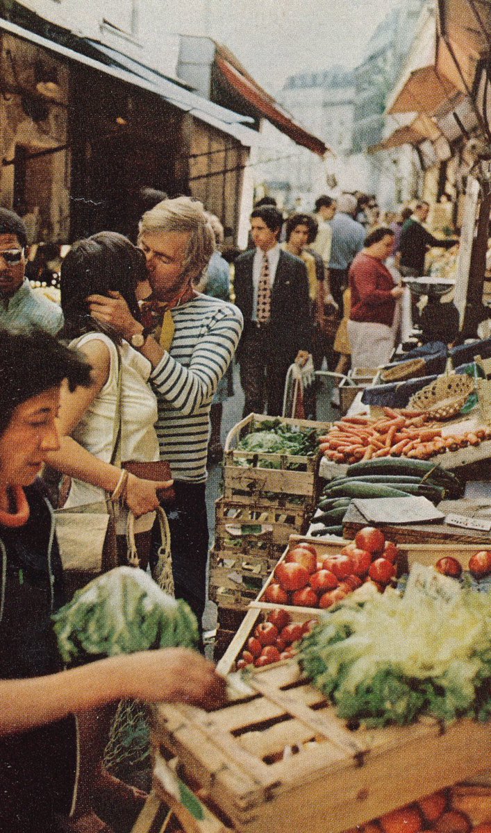 HistoryInPics's tweet photo. Young lovers kiss amid the crowds of a Parisian market, France, 1972. Photograph by Gordon Gahan. https://t.co/lrkNUfA8R5