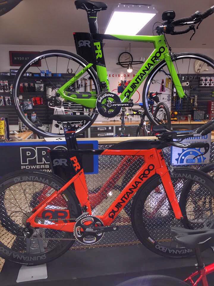 quintanarootri's tweet photo. @Precision_Bikes building bikes! The green one is the new #PRfive and the orange one is the new #PRsix https://t.co/B5l27oDT03