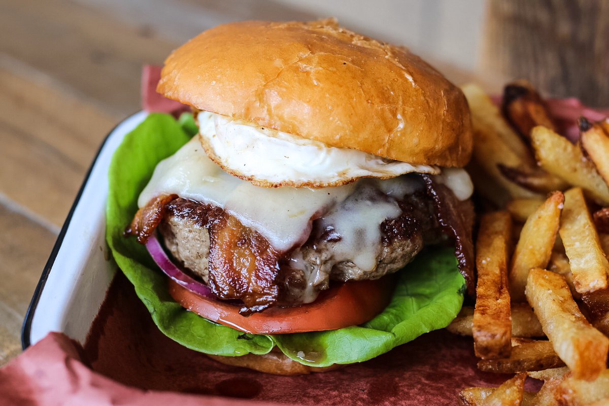 Brunched out this burger from <a href="/JacobysATX/">Jacoby's Austin</a> with a fried egg and bacon. 🍔 Meaty and fulfilling.