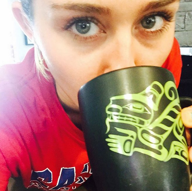 NativeNNW's tweet photo. Miley Cyrus drinks a Native Northwest mug. Wolf by Tsimshian artist Corey Moraes https://t.co/jgCM5t28TD