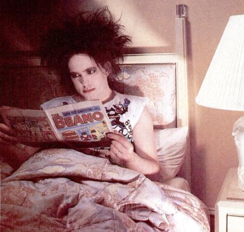 NME's tweet photo. Robert Smith of The Cure having a good read in bed https://t.co/9zVWxigQO9