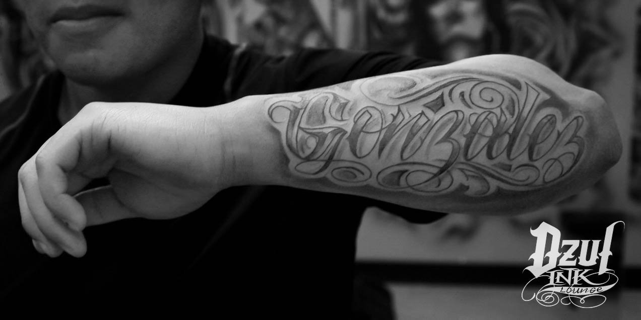 gonzalez in cursive tattoos