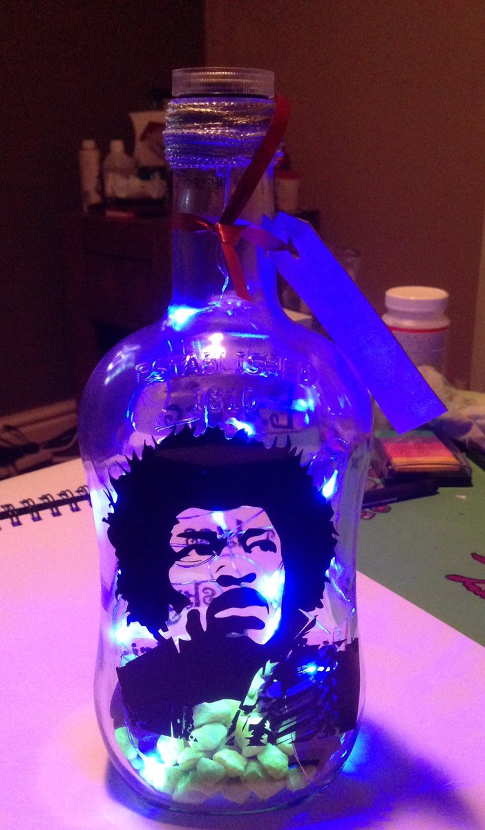 monkeydebris_c's tweet image. Upcycled Jimi Hendrix light. Jura bottle with blue LED&apos;s &amp;amp; coloured stones.