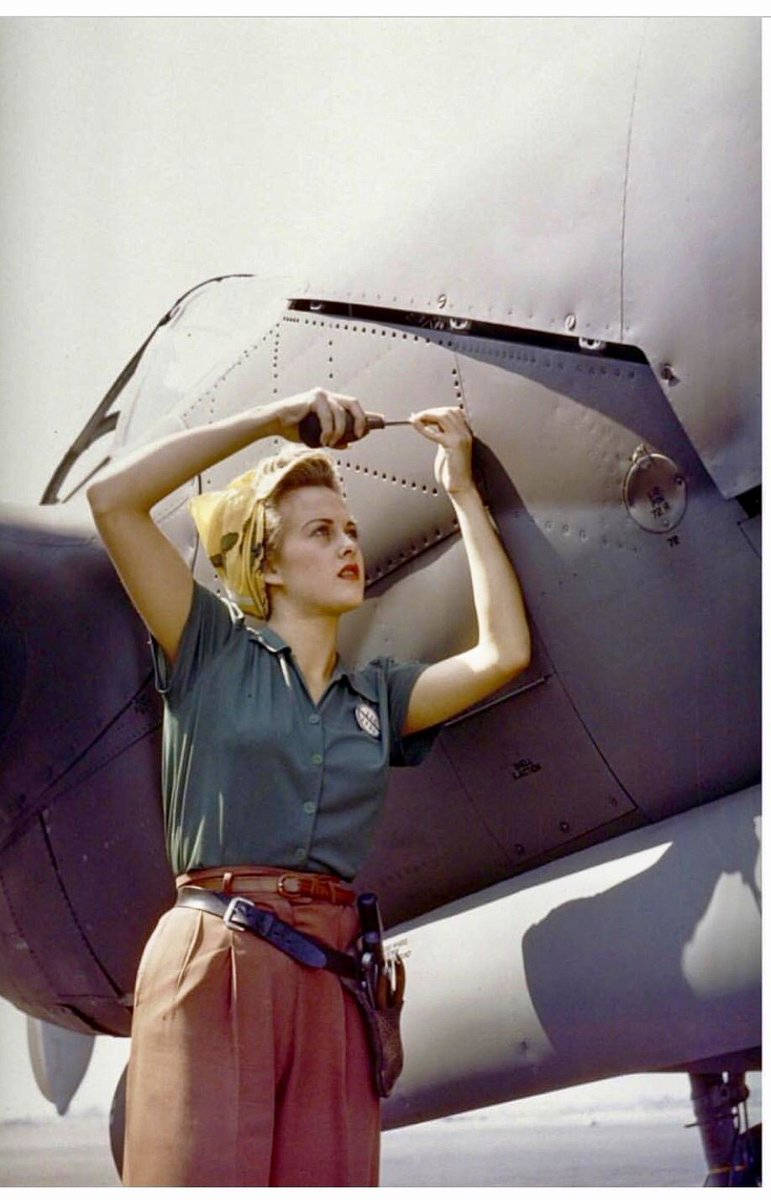 A female Lockheed employee works on a P-38 Lightning, Burbank, CA, 1944.