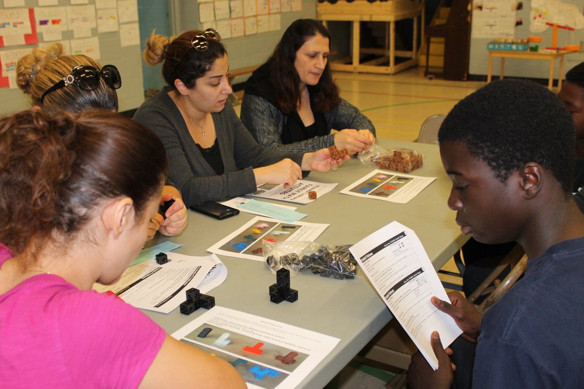 StAndrewTCDSB's tweet photo. Student leaders exploring geometric & spatial relationships, with Kindergarten parents, at Family Math Day. #M4YC @tulimari @drbevcaz @TCDSB https://t.co/yUyNrtNPjV