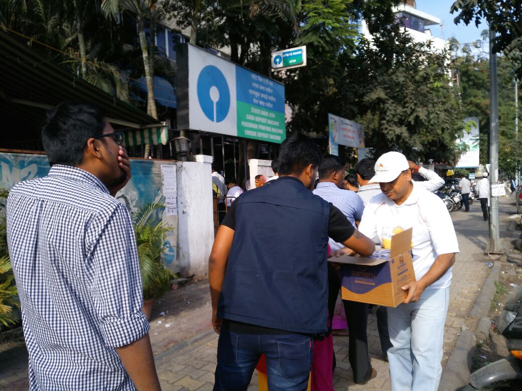 SharadBhojane's tweet photo. Pune Volunteers making life lil easy for ppl standing in queues. #Demonetization 
@ArtofLiving @SriSri @PMOIndia https://t.co/wKt26LL1cB