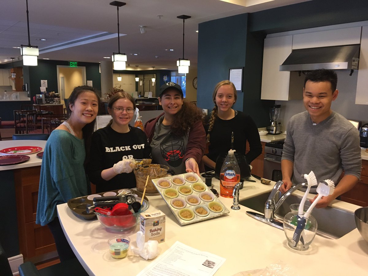 Members of Colleges Against Cancer having a great time baking muffins for the Hope Lodge