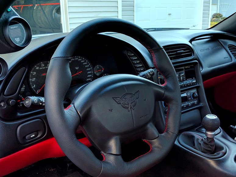 Flat Bottom Steering wheel anyone? :-)

redlinegoods.com/C5fbwheel.php