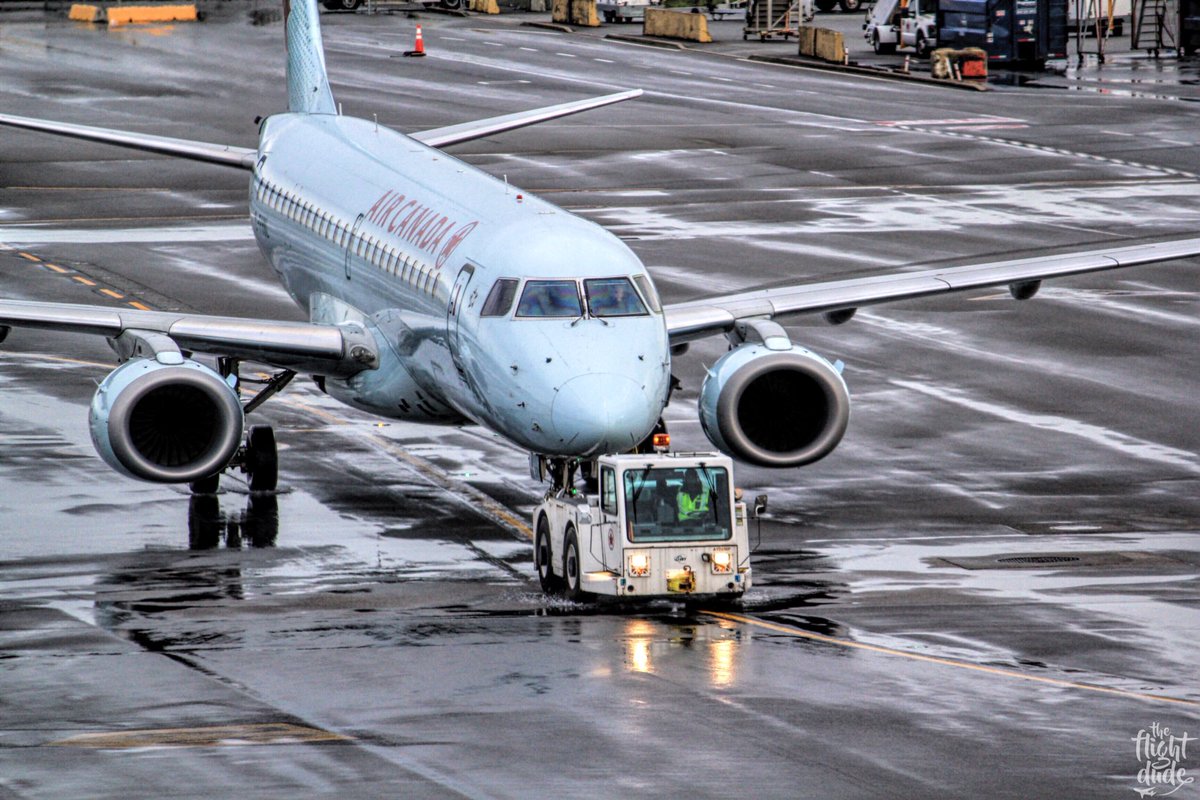 theflightdude's tweet photo. The @embraer E190 from @AirCanada being towed to the gate at @yvrairport and preparing for its next assignment, flight AC534 #YVR - #ORD https://t.co/3CQZOIEnud