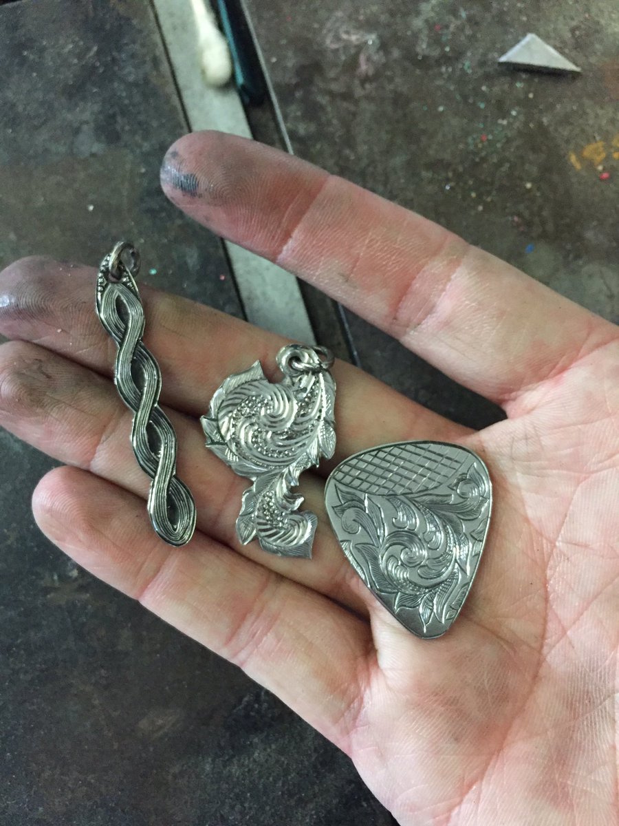 AndrewLeeAdams1's tweet photo. Working hard and getting dirty making beautiful engraved metal  pendants and guitar pick #engraving #engrave #art #design #pendant #guitar https://t.co/hA34NajeRi