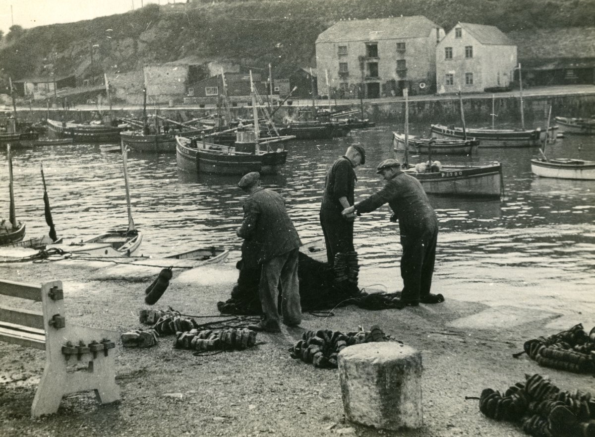 musecornishlife's tweet photo. Today's #PhotoOfTheWeek shows three fishermen mending nets on the quay on Porthleven inner harbour circa 1950 https://t.co/gldc8oRWyf