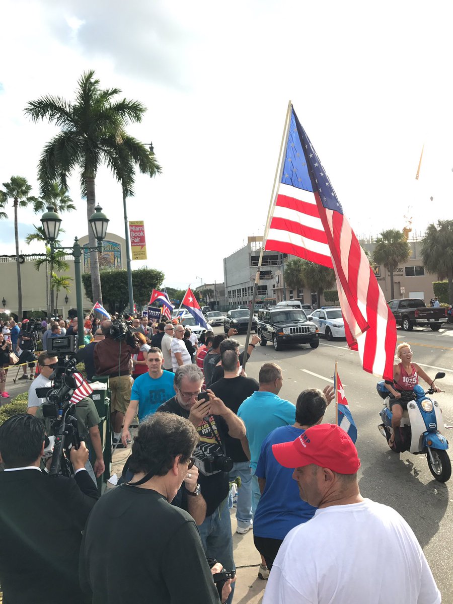 moody's tweet image. Police have opened up the street here in Little Havana. Crowds cheering. Cars honking. Music blaring in celebration. #Castro