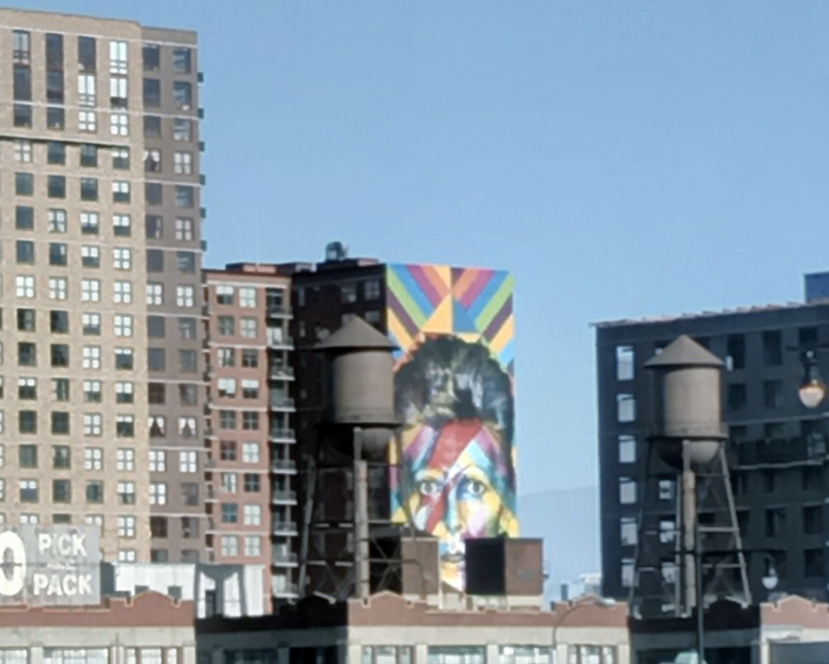 DavidBoles's tweet photo. Love this giant David Bowie mural lording over Jersey City -- spying on us from betwixt ancient Water Towers! https://t.co/kJFBuw7WWG
