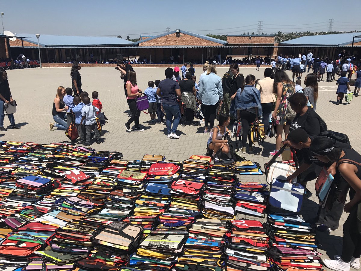 claireconchar's tweet photo. We're at Reshomile Primary handing out deskbags (recycled billboards repurposed into school bags) w @converse team https://t.co/b5yemM3l3P