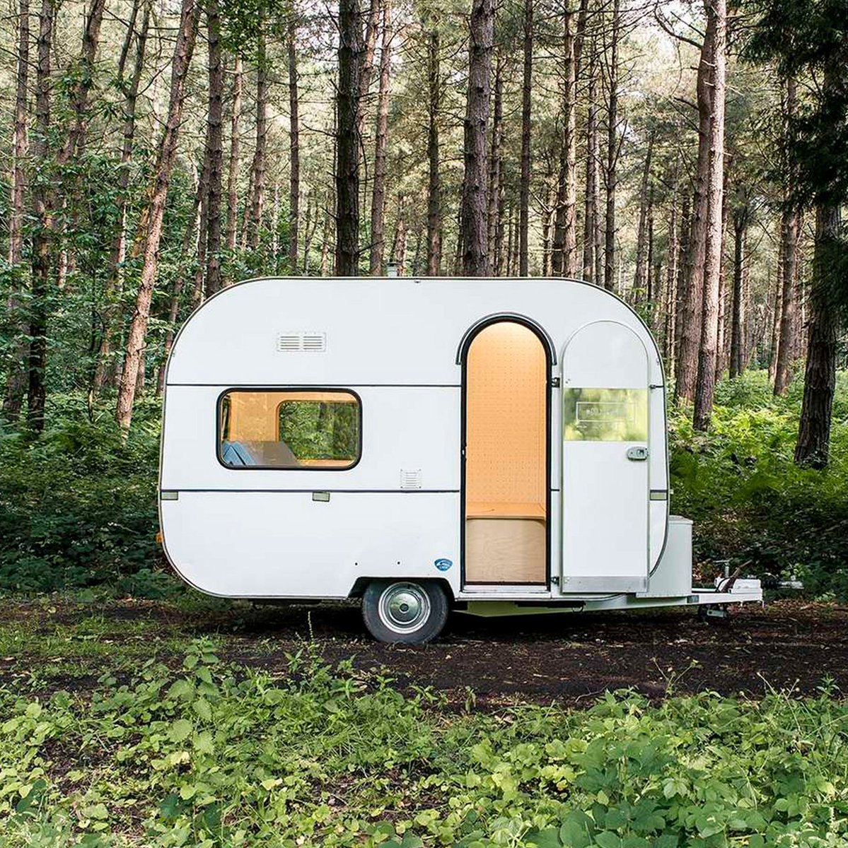 dezeen's tweet image. Caravan transformed into a mobile studio with pop-up table and pegboard walls by award winning design office: dezeen.com/?p=983999