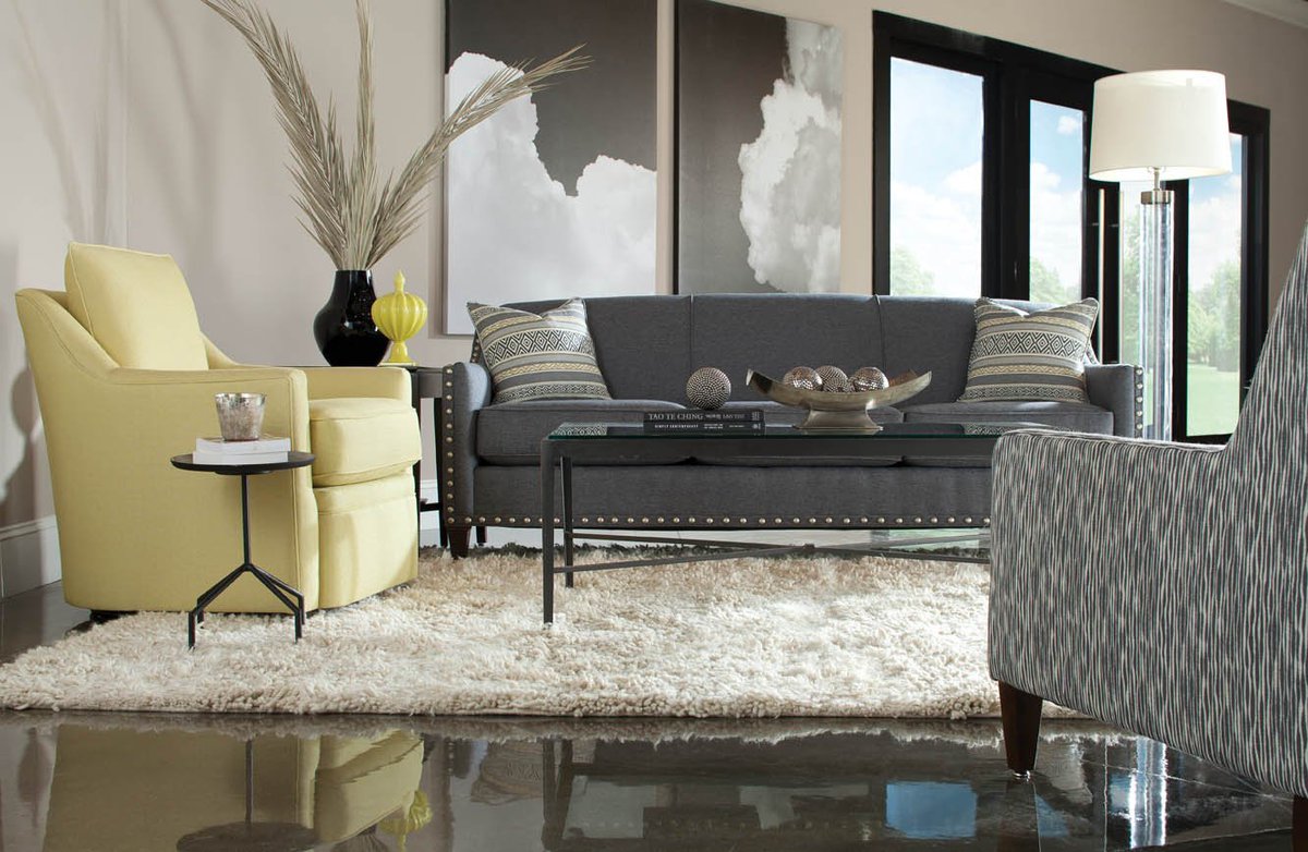 Our comfortable Hollins swivel chair in citrus and our Rockford sofa in graphite make for the perfect color combination! #interiordesign