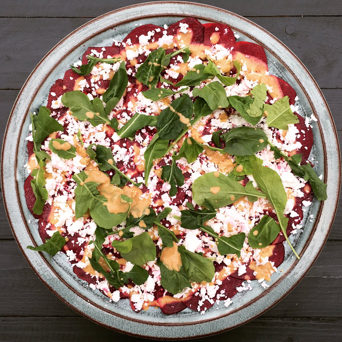 Festive red and green beetroot carpaccio with creamy Danish feta, peppery rocket and a mustard dressing #delishsisters #lunching
