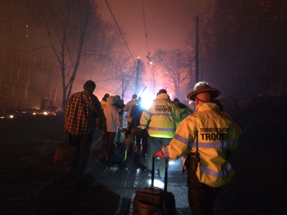 TNHighwayPatrol's tweet photo. Troopers walked into areas of Gatlinburg, Tn that were surrounded by fire to remove those who were trapped by flames. https://t.co/9r2lkAVy19