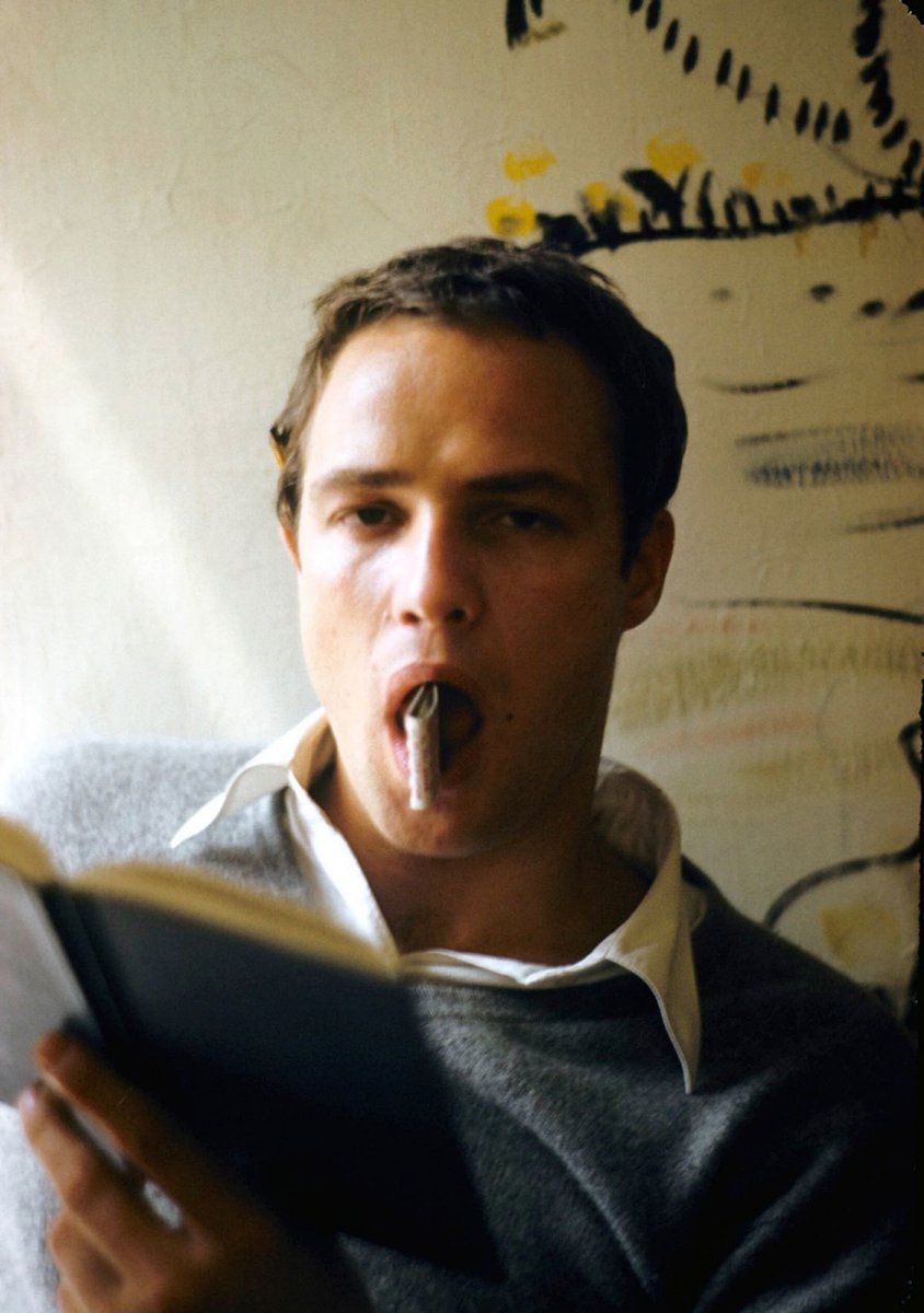 Marlon Brando circa 1950's; book in hand (and matchbox in mouth)