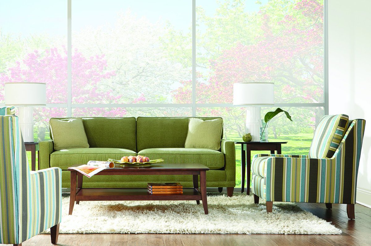 Stripes help add interest to a living room while tying in your accent colors perfectly! The natural tones of this room is sure to inspire!