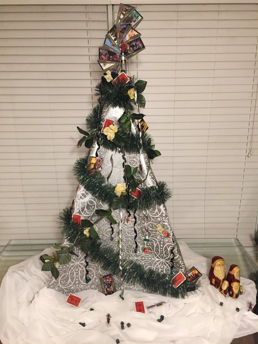 AmyM_Cook's tweet image. Tabletop gaming "tree" is up (courtesy my camera tripod, wrapping paper, garland and game components)!!