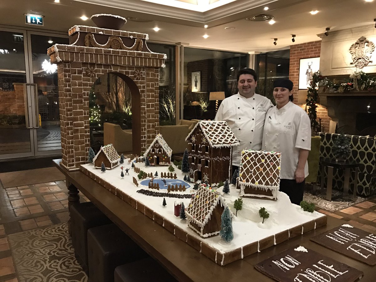 SopwellHouse's tweet image. Our pastry team with their gingerbread village and Sopwell Arch
