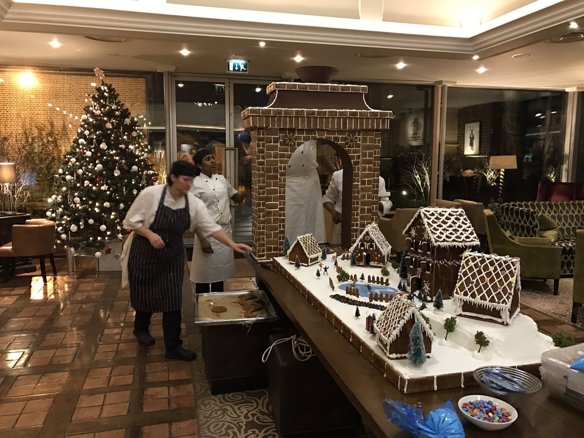 SopwellHouse's tweet image. Our pastry team with their gingerbread village and Sopwell Arch