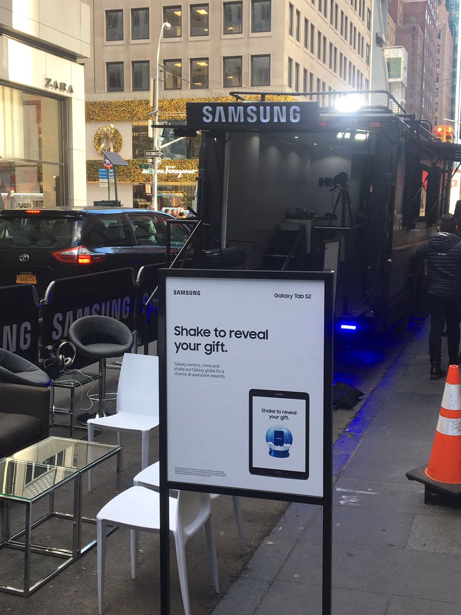 solomonpkane's tweet photo. 52nd and 5th in #nyc. Galaxy owners shake snow globe to win. That's 2 items not allowed on planes: #snowglobes and @SamsungMobile phones. https://t.co/oha6aHsNKM