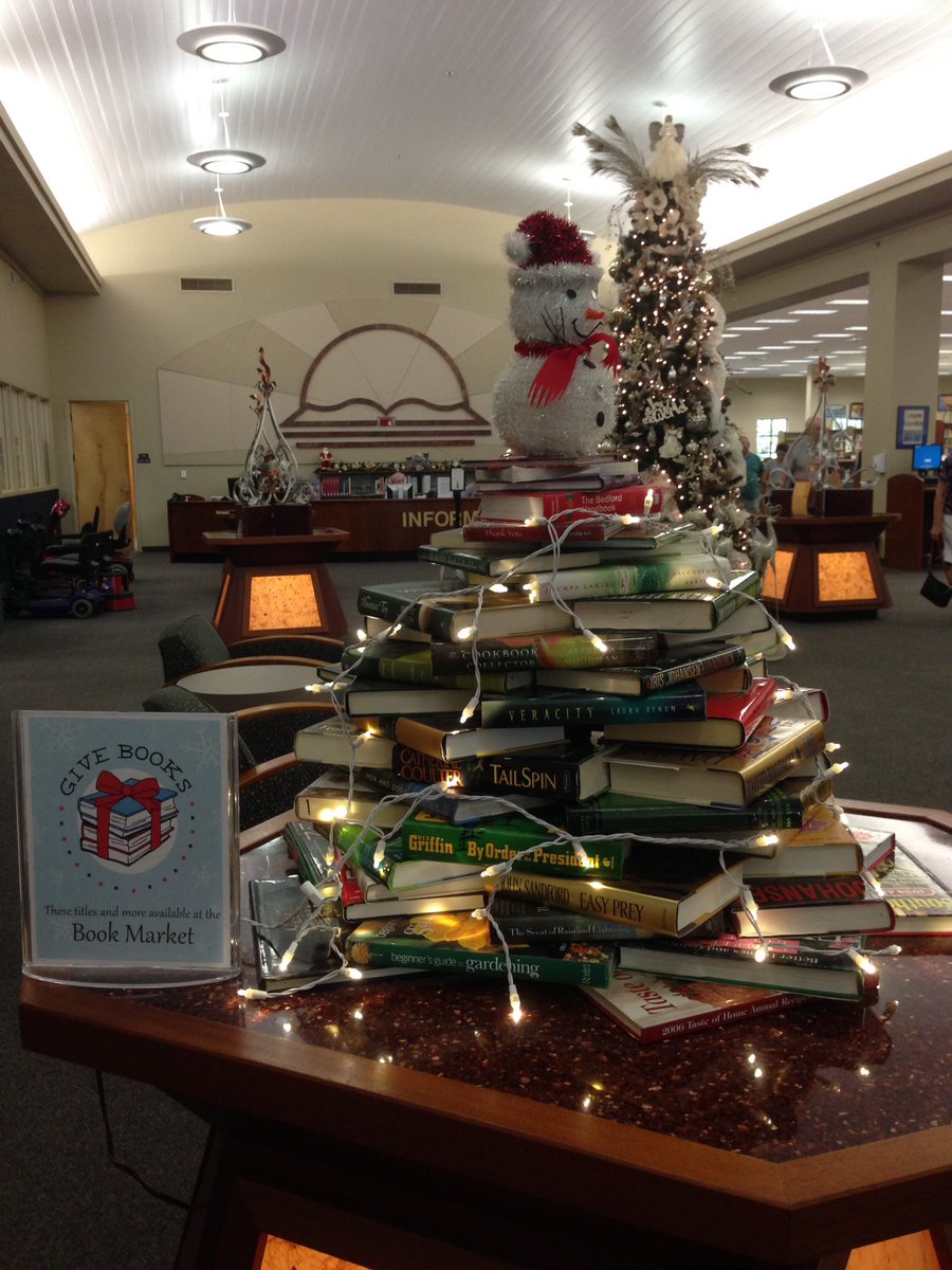 MCPLibrary's tweet photo. @TweetFLAlibrary Here's our cute lil #booktree near our grand holiday tree at our Headquarters-Ocala library. https://t.co/Y5yThIsCcx
