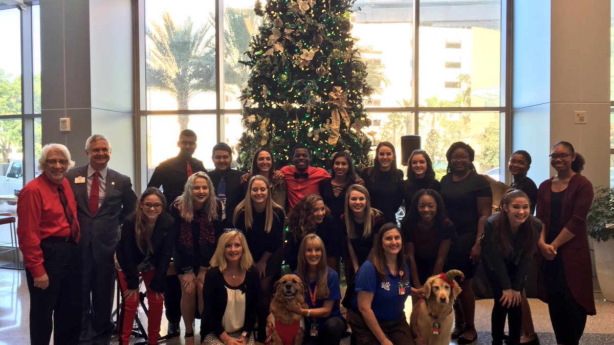 orlandohealth's tweet photo. Mark Jones, President of ORMC, joins choir members & members of our @PetSmart #PawsForHope #PetTherapy team at our #ChristmasTree lighting. https://t.co/0oeg6tFYzk