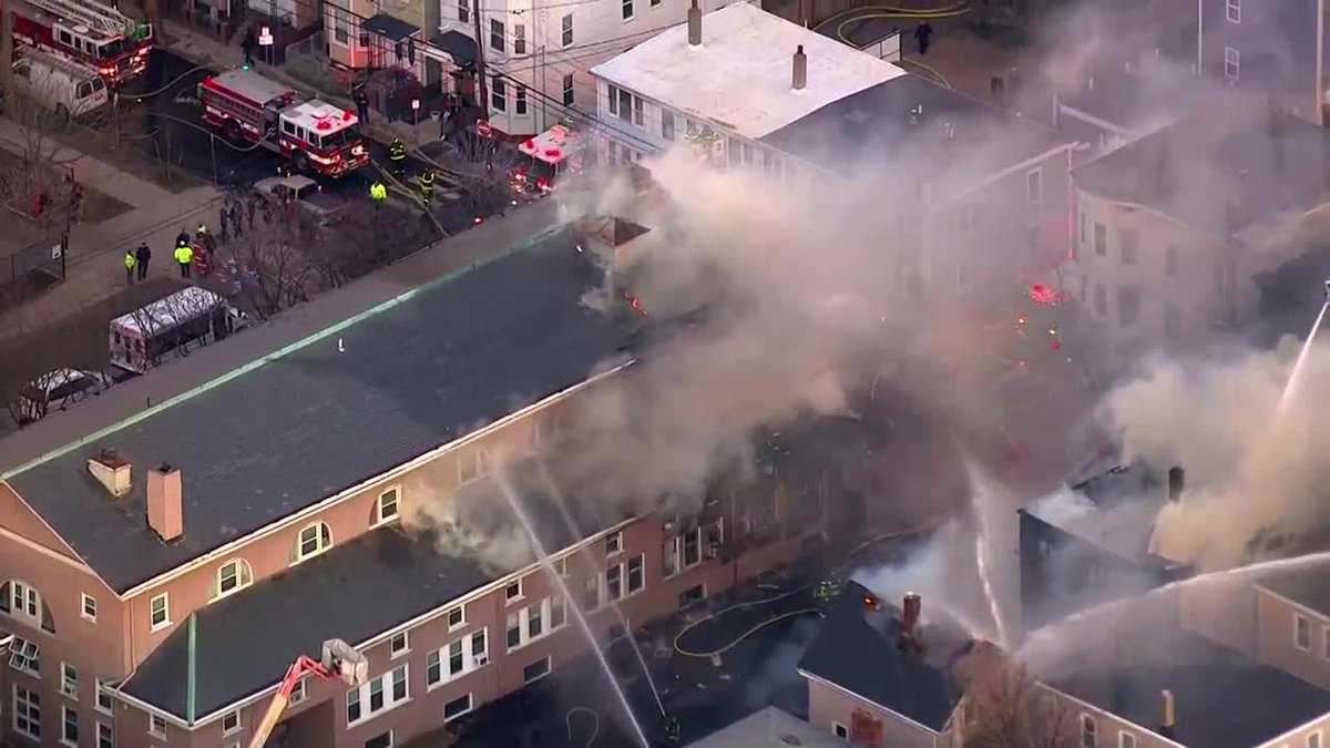 WCVB's tweet photo. Massive fire burning in #Cambridge. 10-alarms. 4 buildings involved, 1 collapsed. https://t.co/BUPotnf21R https://t.co/SrEQvDqQcO