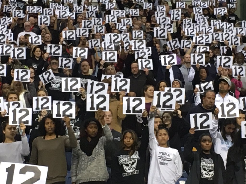 SCUCISD's tweet photo. Steele HS fans hold up #12 to honor Churchill's fallen teammate Josh Pollard during the Chargers' school song. #UnitedInLove #WeAreSCUC https://t.co/uTuO3yMh9O