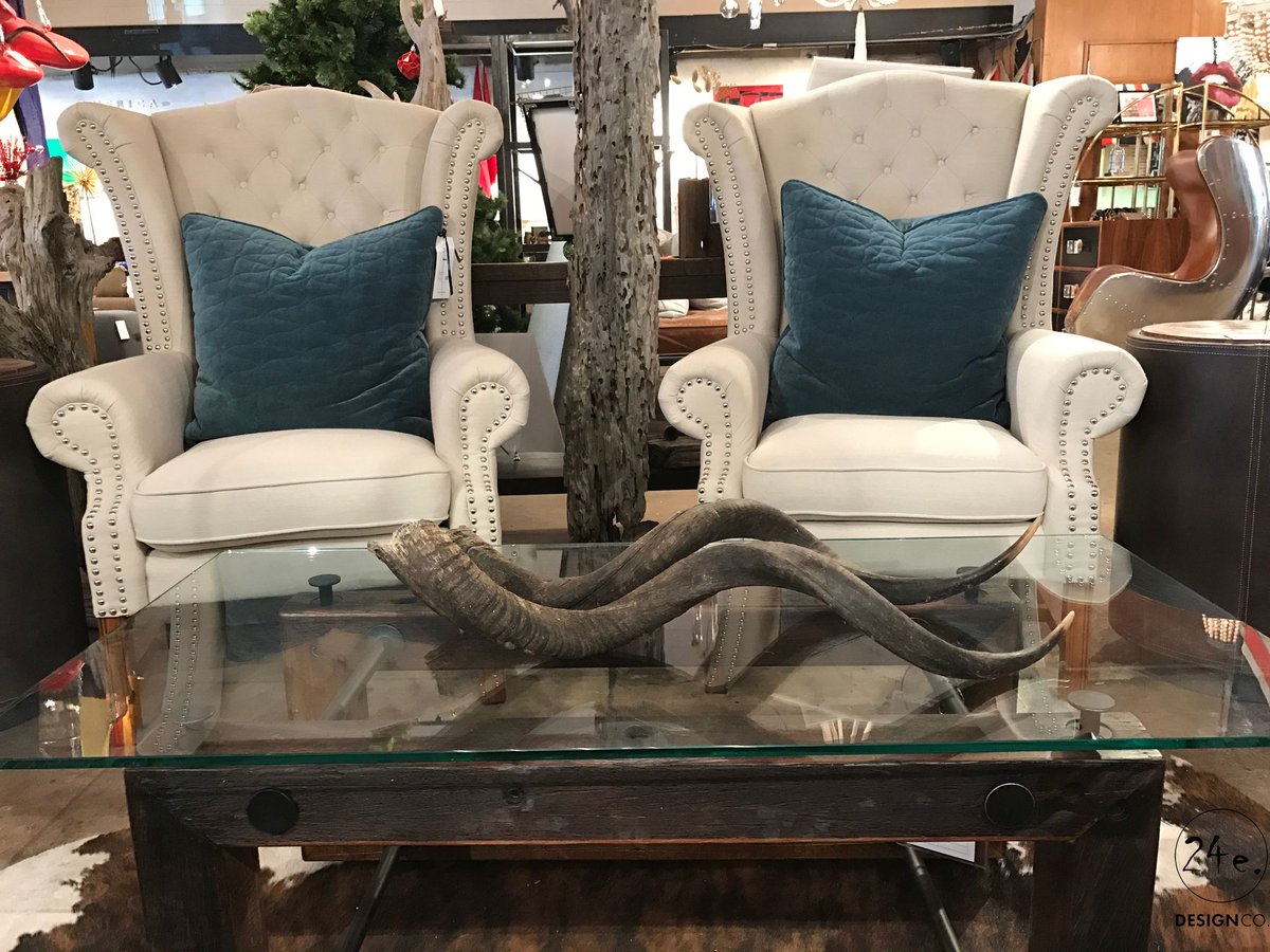 We love the juxtaposition of these modern armchairs and the natural birch tree decor! Visit us in-store to get more design inspo! #24estyle