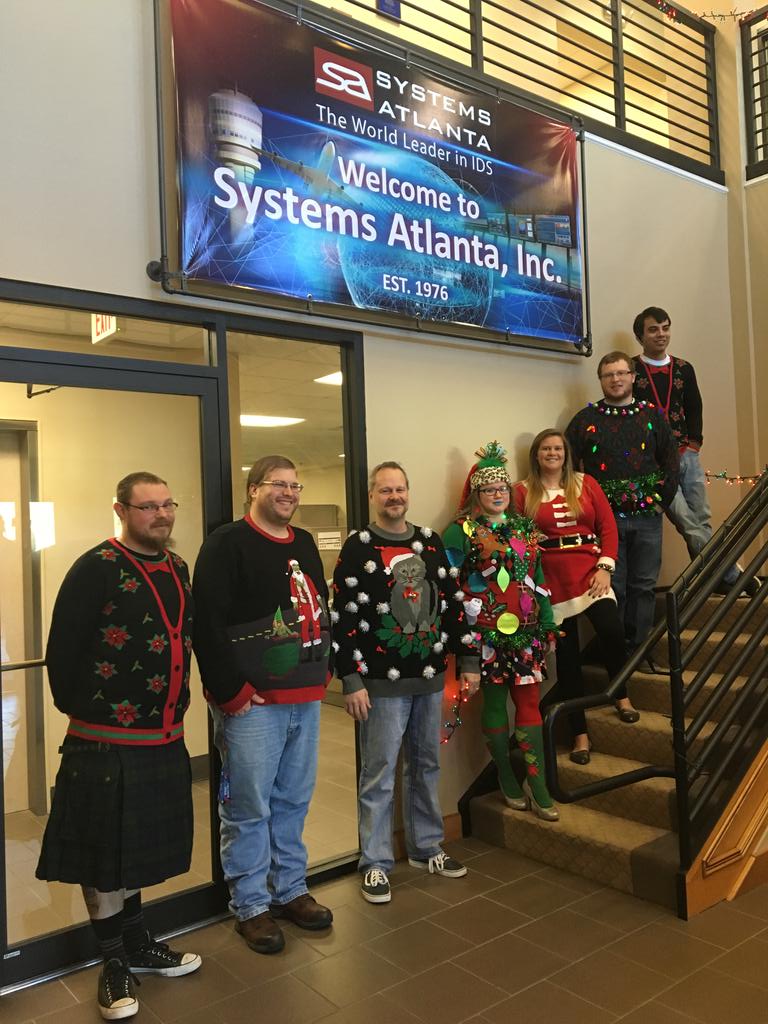 SystemsAtlanta's tweet photo. Getting into the holiday spirit at the office…bells, lights, and of course ugly sweaters! #Sysatl #uglysweatercontest https://t.co/lHrZMafAWT