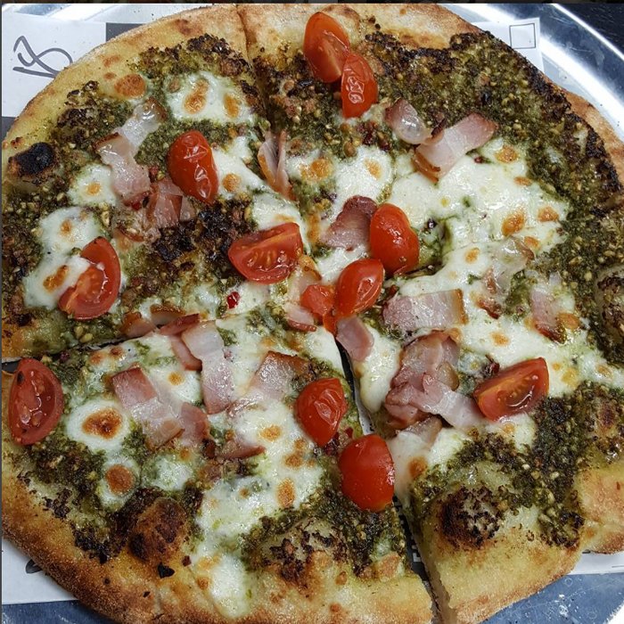 Thin &amp; crispy sourdough base, green pesto sauce, chilli flakes, cherry tomatoes, pancetta and mozzarella! #pizzaoftheday #pizza #foodie