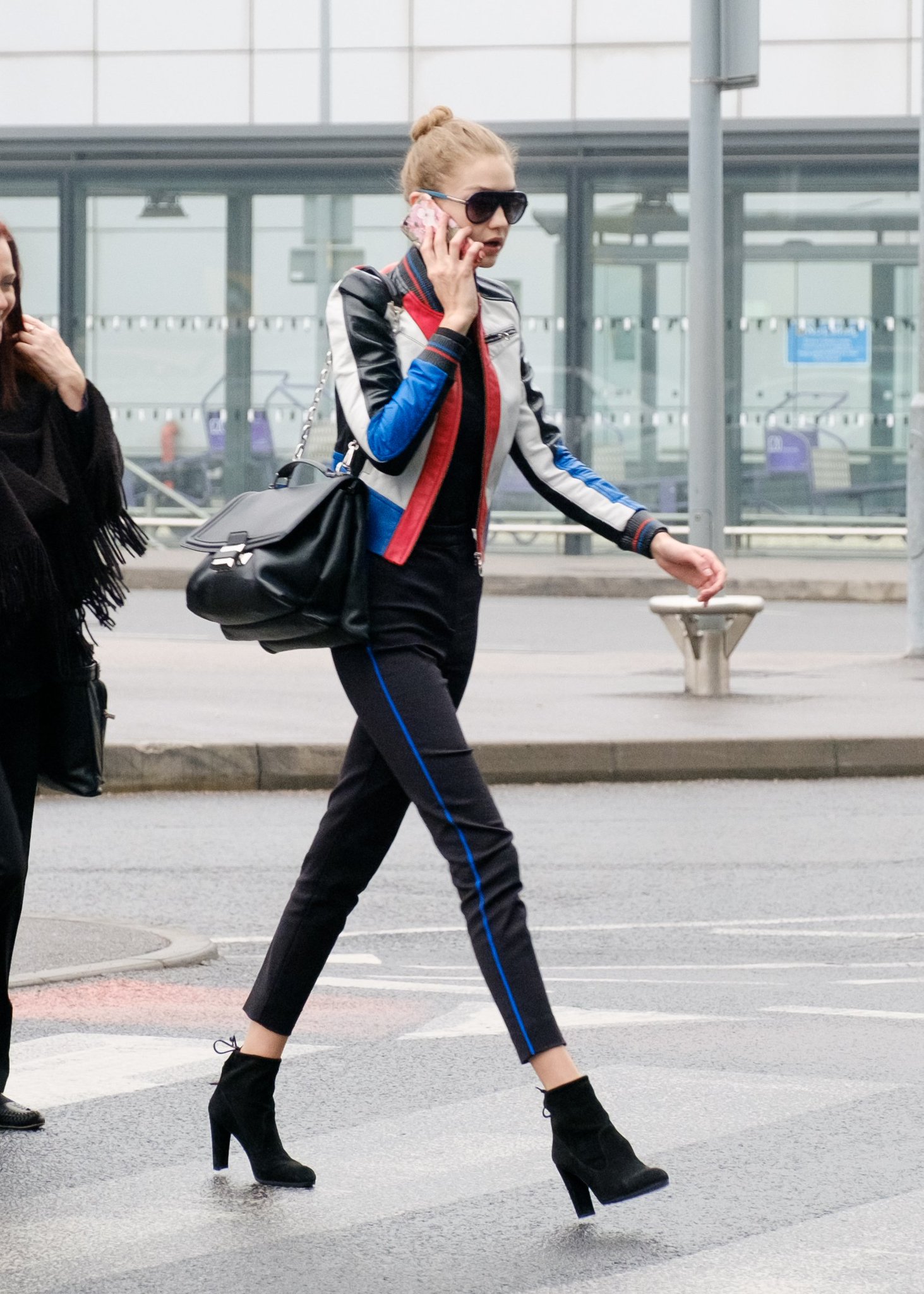 Versace - Gigi Hadid masters the airport style carrying the brand new black  #VersaceDV1 bag.