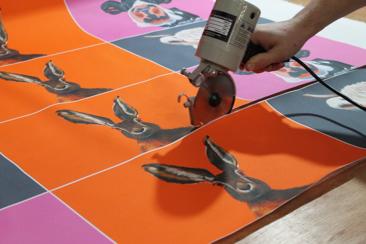 David has been cutting and preparing the panels ready for our seamstresses to sew them onto our black cotton aprons.

Keep your eyes peeled!