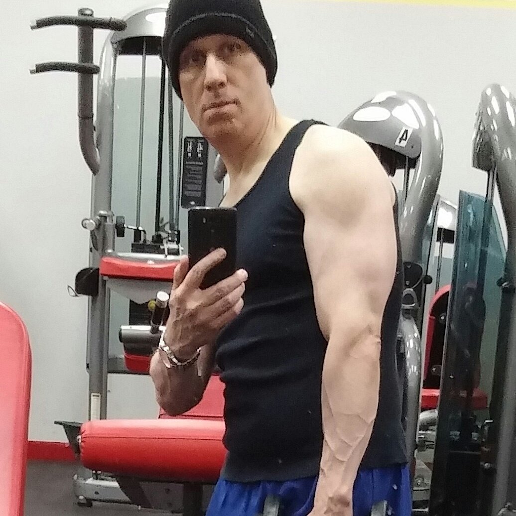 Early gym checking out the "gun show".  I wonder why they call me the "other white meat" Dad?  😉